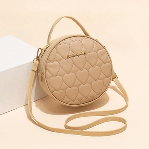 Retro beige round handbag with heart quilting and golden logo on geometric background