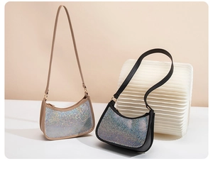 Close-up of beige and black sequined underarm bags with sparkling rhinestone texture