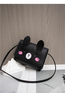 Detail shot of mini black PU leather crossbody bag with cute animal face and ears
