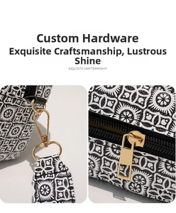 Detail of high-quality golden hardware with textured zipper and spring clasp on printed bag
