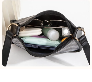 Top view of the interior space of the contrast leather handbag with daily essentials