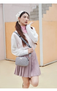 Detail of crossbody camera bag featuring vintage geometric patterns and jacquard strap