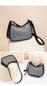 Detail of black rhinestone hobo bag showing sparkling crystal mesh and gold zipper
