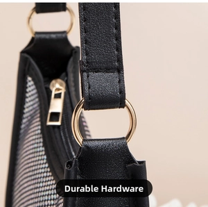 Close-up of golden hardware and leather strap on luxury rhinestone shoulder bag