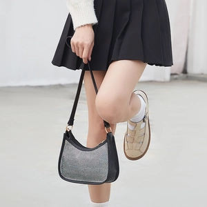 Sparkly black and white checkered hobo bag for women worn with a classic preppy outfit