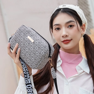 Crossbody camera bag with geometric print and branded fashion strap for women