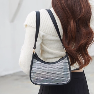 Chic shell-shaped baguette bag with sparkling rhinestones and black leather trim details