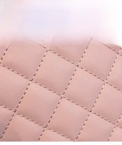Detailed macro view of pink quilted leather texture and high-quality stitching on the bag
