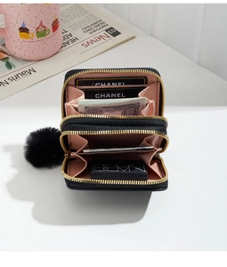 Internal view of women's black quilted double-zipper wallet with multiple card slots and cash