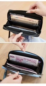 Macro view showing the spacious interior of a zipped Saffiano leather wallet for women