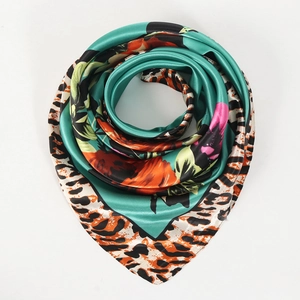 Detail of satin scarf featuring floral rose patterns and leopard print borders