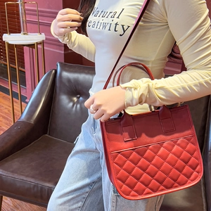 Red quilted leather tote bag with elegant top handle and strap for women's daily use