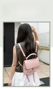 Fashionable pink quilted backpack with gold turn-lock closure shown on a model