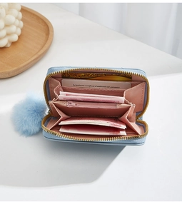 Interior detail of light blue accordion wallet showing card slots and zipper pocket