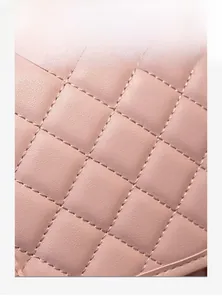 Close-up of pink quilted faux leather material with fine stitching and soft texture