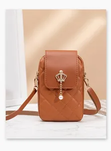 Detail of brown quilted PU leather phone bag with gold crown and pearl pendant