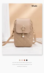 Detail of khaki quilted PU leather phone bag featuring a gold crown and pearl charm