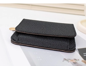 Close-up of black lychee grain leather wallet showing multi-slot structure and texture