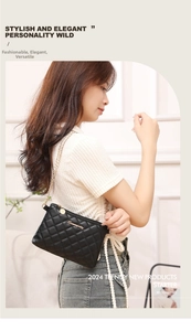 Close-up of black quilted small square bag featuring gold chain strap and metal logo