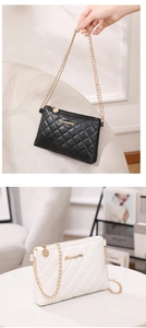 Close-up of quilted chain crossbody bags in black and white with gold Sunnycity logo