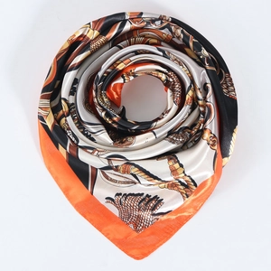 Detailed view of large satin scarf with orange and black equestrian chain pattern prints