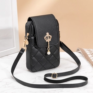 Vertical quilted crossbody phone bag in black with pearl crown charm on marble surface