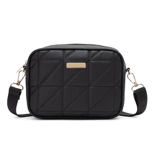 Minimalist black quilted crossbody bag with gold hardware and wide fabric shoulder strap