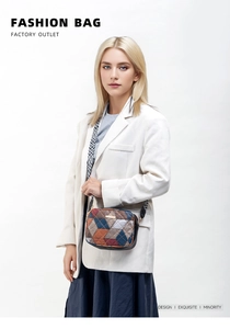 Fashionable crossbody bag with geometric contrast panels and wide woven shoulder strap
