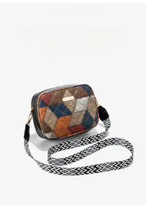Detail of a color-block crossbody bag with quilted texture and geometric wide strap