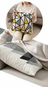 Macro view of geometric linen pillowcase with yellow and grey triangle printed patterns
