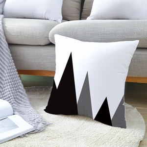 Minimalist geometric mountain print pillowcase on a plush carpet in a modern living room