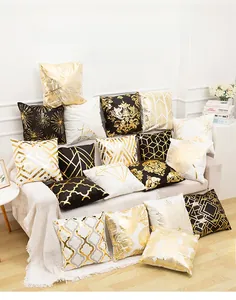 Detail of gold foil stamped pillow covers with geometric and marble patterns on a sofa