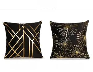 Detail of black and gold pillow covers with geometric lines and starburst patterns