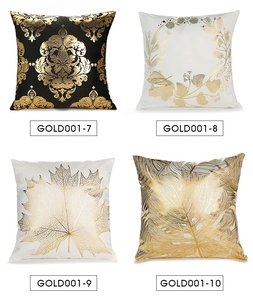 Macro shot of four decorative pillowcases with gold foil leaf patterns on white and black