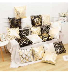 Detail of luxury gold foil pillow covers with geometric and marble patterns for sofa