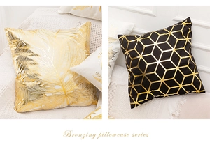Close-up of gold bronzing tropical leaf and geometric patterns on velvet pillowcases