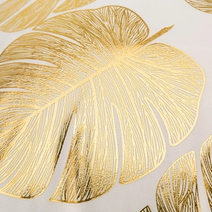 European style pillow case with golden monstera leaf pattern on white fabric
