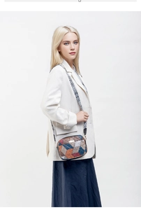 Detail of crossbody bag with colorful geometric patchwork and ethnic style shoulder strap