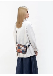 Detail of bohemian geometric woven crossbody bag with stylish patterned wide strap