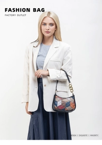 Close-up of quilted patchwork shoulder bag with chunky metal chain and colorful patterns
