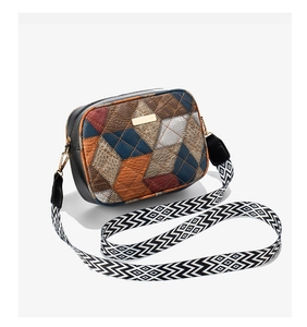 Detailed view of retro color-block crossbody bag with quilted faux leather and gold plaque