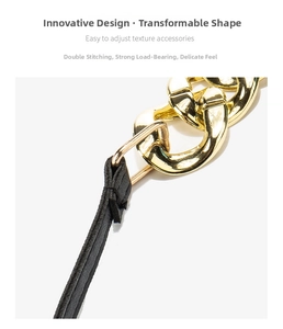 Detail of reinforced double stitching on premium black leather strap with gold chain links