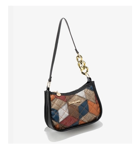 Detail of color block shoulder bag with gold chain strap and lychee grain texture