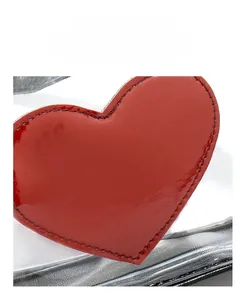 Close-up of red heart patch with premium stitching on transparent PVC crossbody bag
