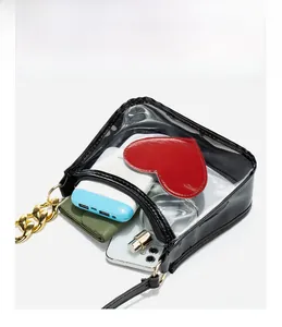 Detailed view of clear PVC crossbody bag showing capacity for phone and wallet