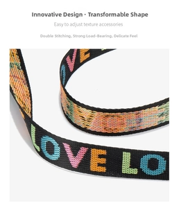 Detail of wide woven shoulder strap featuring colorful LOVE embroidery and durable stitching