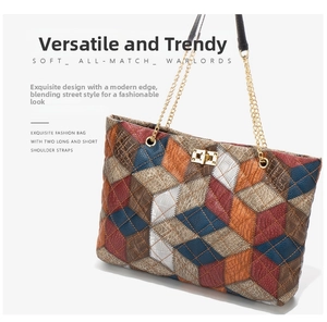 Detail of trendy patchwork tote bag with crocodile pattern and gold twist lock closure