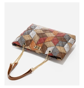 Detail of multi-color diamond lattice bucket bag with gold clasp and chain strap