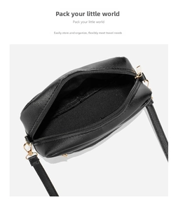 Internal view of black pebble leather crossbody bag with zipper and textile lining