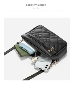 Detail view of the black quilted crossbody bag interior holding daily essentials
